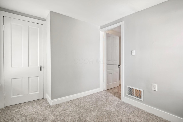 empty room featuring light colored carpet