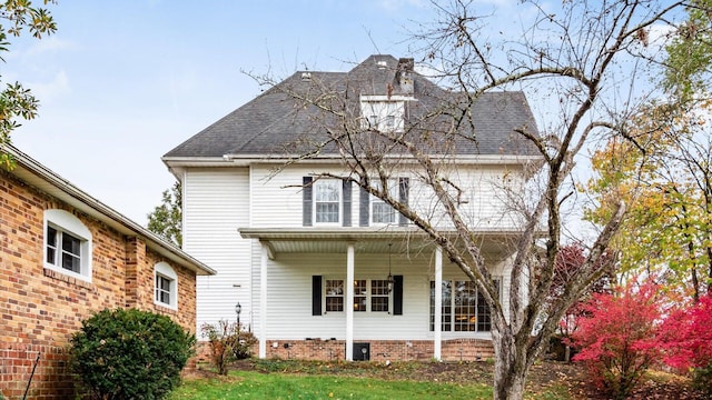 rear view of property with covered porch