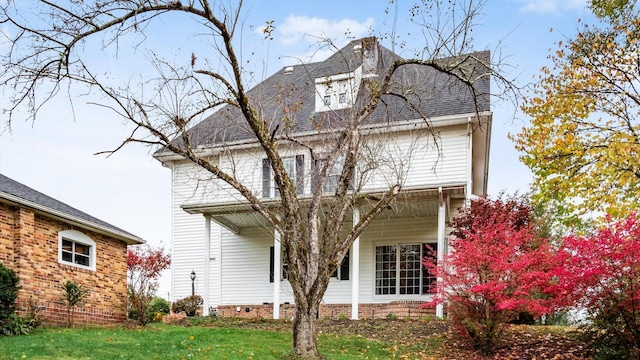 rear view of property with a yard