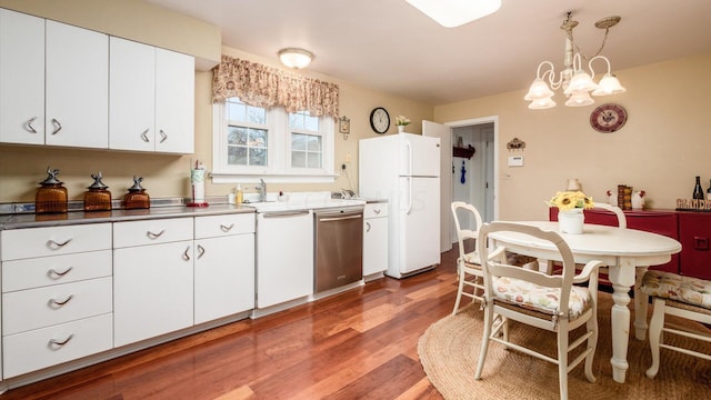 kitchen with white cabinets, decorative light fixtures, dark hardwood / wood-style flooring, and white appliances