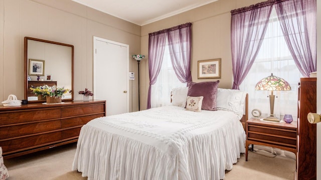 carpeted bedroom featuring crown molding