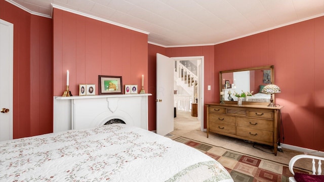 bedroom featuring crown molding and light carpet