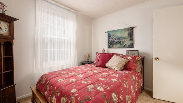 carpeted bedroom featuring ornamental molding