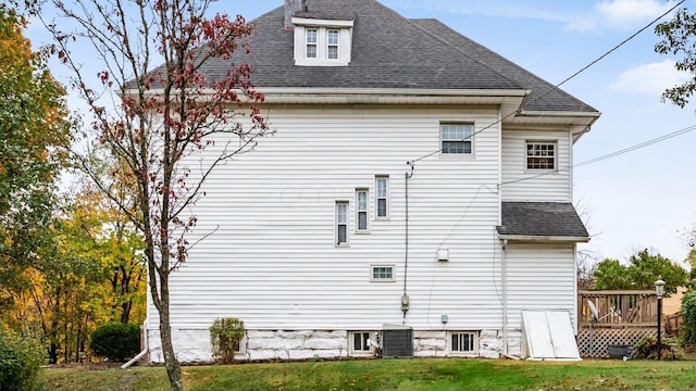 view of side of home featuring a yard and a deck