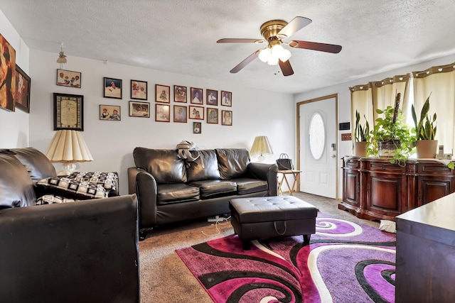 carpeted living room with ceiling fan and a textured ceiling