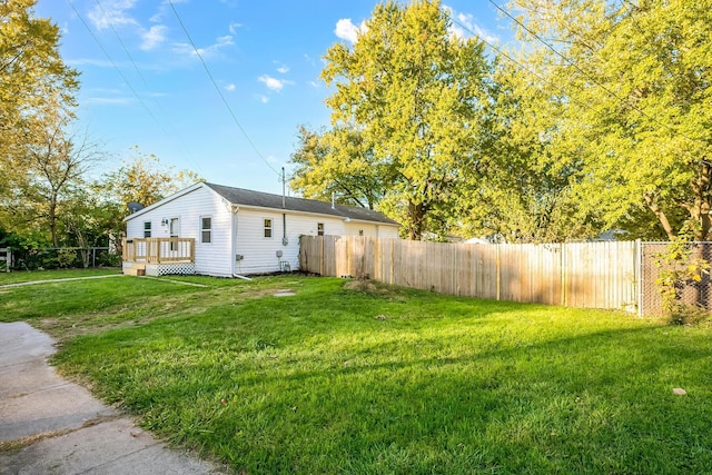 exterior space featuring a wooden deck and a front lawn