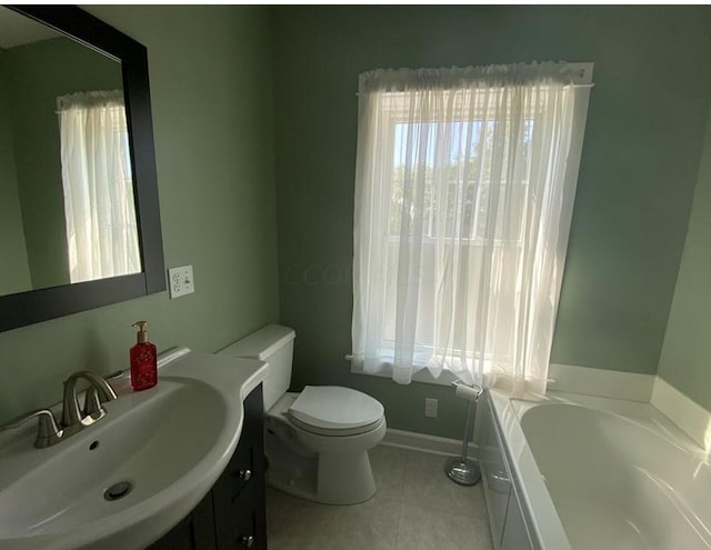 bathroom with a tub to relax in, tile patterned floors, vanity, and toilet