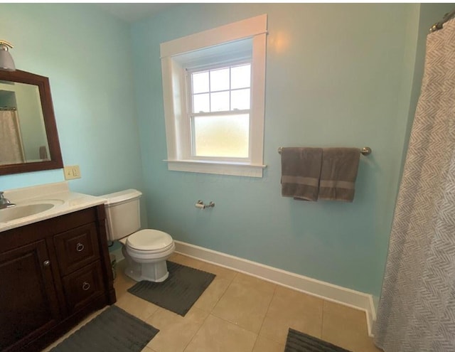 bathroom with tile patterned flooring, vanity, and toilet