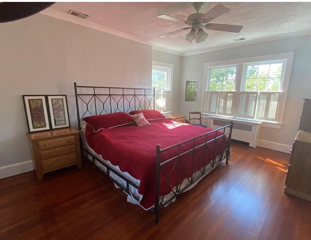 bedroom featuring radiator, ceiling fan, dark hardwood / wood-style floors, and ornamental molding