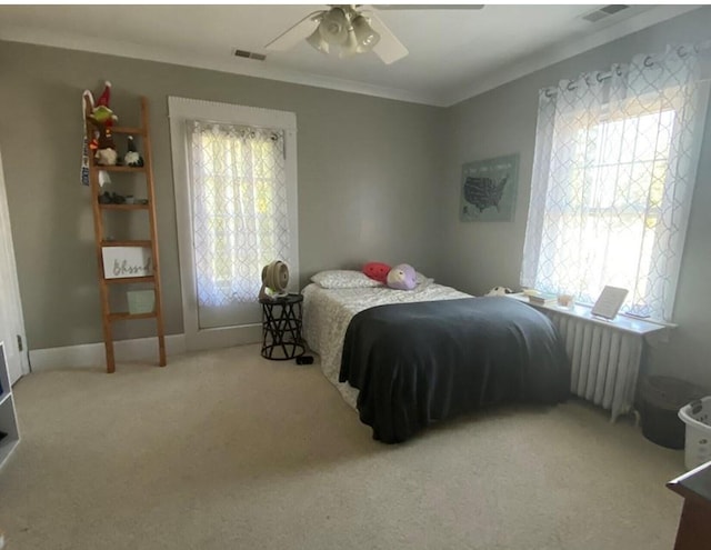 bedroom featuring light carpet, radiator, multiple windows, and ceiling fan