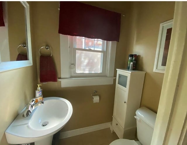 bathroom featuring tile patterned floors, sink, and toilet