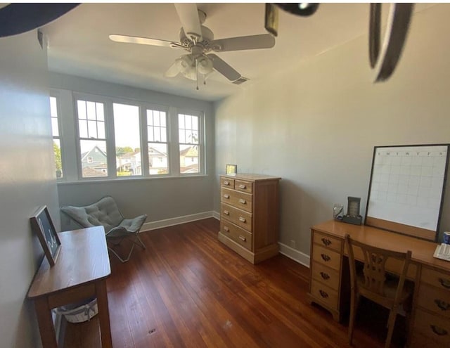 living area featuring ceiling fan and dark hardwood / wood-style flooring