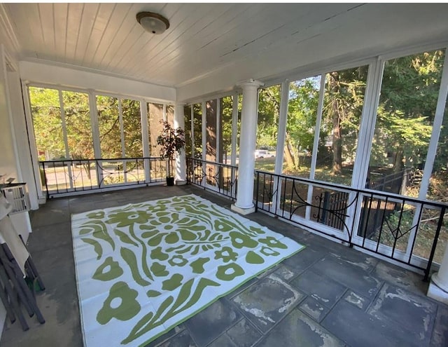 unfurnished sunroom with wooden ceiling