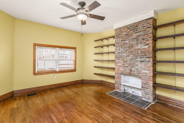 2402 E Ave, Columbus, OH 43202 - unfurnished living room featuring wood finished floors, a ceiling fan, and a fireplace