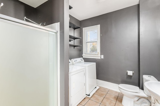 2402 E Ave, Columbus, OH 43202 - bathroom with washing machine and clothes dryer, tile patterned flooring, and a shower