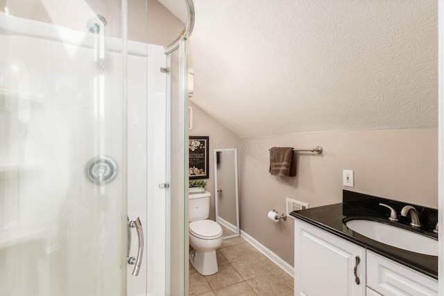 bathroom with tile patterned flooring, vaulted ceiling, toilet, a shower with door, and vanity