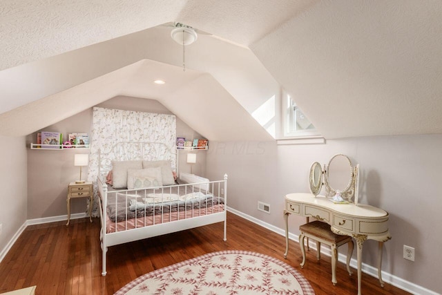 bedroom with ceiling fan, wood-type flooring, a textured ceiling, and vaulted ceiling