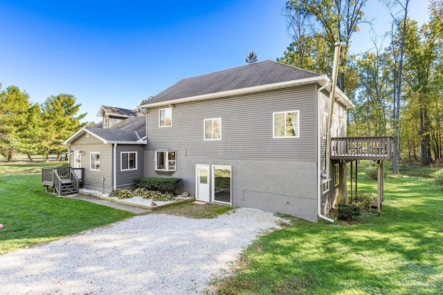 exterior space featuring a lawn and a wooden deck