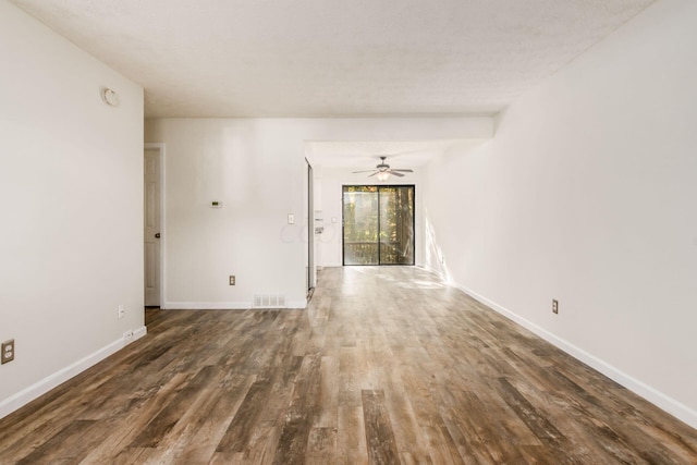 spare room featuring a textured ceiling, dark hardwood / wood-style floors, and ceiling fan