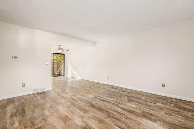 spare room featuring hardwood / wood-style floors, a textured ceiling, and ceiling fan