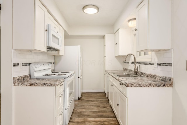 kitchen with white appliances, sink, dark hardwood / wood-style floors, tasteful backsplash, and white cabinetry