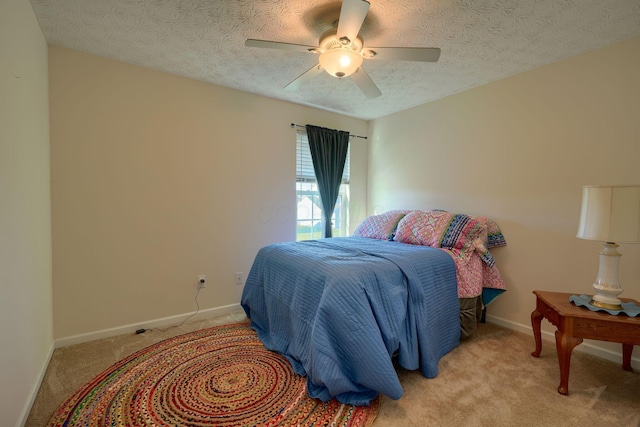 carpeted bedroom with a textured ceiling and ceiling fan