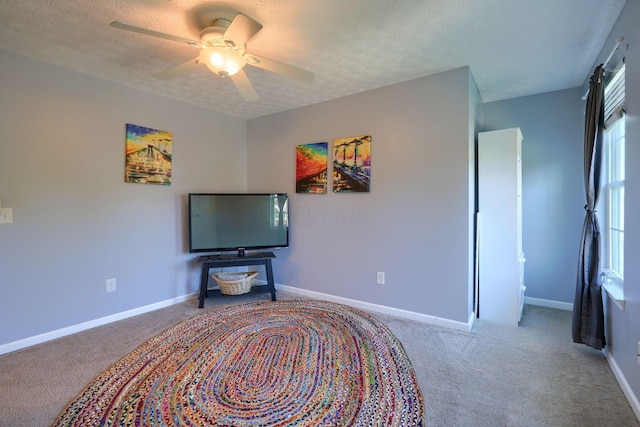 interior space with ceiling fan and a textured ceiling