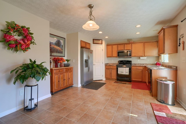 kitchen featuring pendant lighting, a textured ceiling, light tile patterned floors, and black appliances