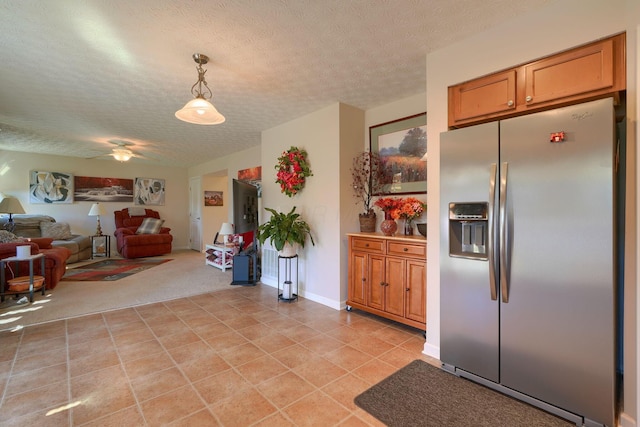 kitchen featuring light carpet, stainless steel fridge with ice dispenser, a textured ceiling, and pendant lighting