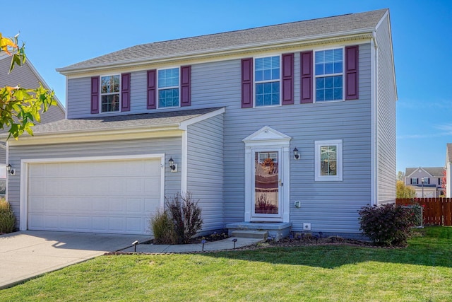 colonial home featuring a front yard and a garage