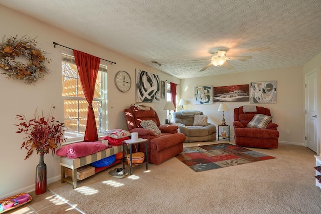 carpeted living room featuring ceiling fan and a textured ceiling