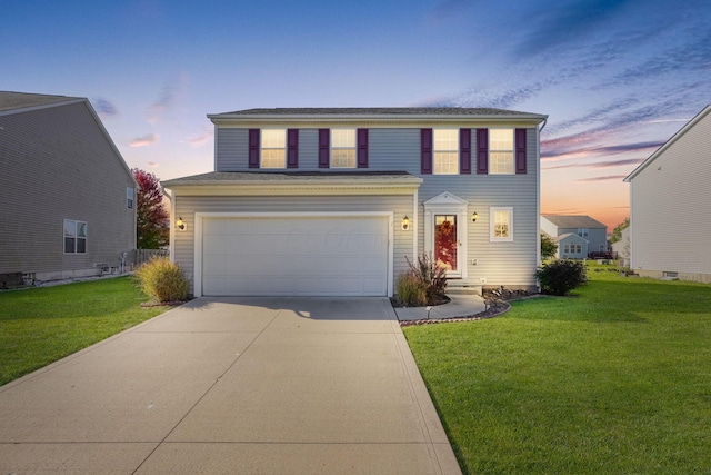 view of front of property featuring a lawn and a garage