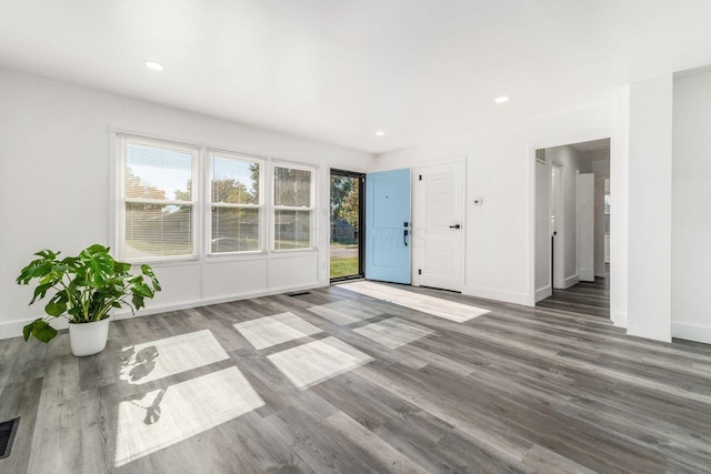 unfurnished living room with hardwood / wood-style flooring