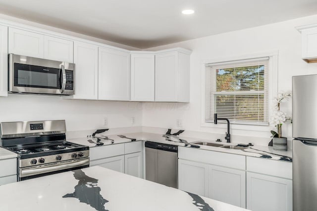 kitchen featuring white cabinets, sink, and appliances with stainless steel finishes