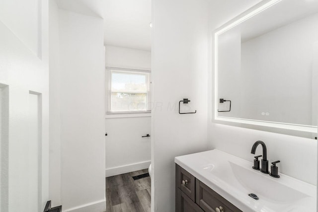 bathroom featuring hardwood / wood-style floors and vanity