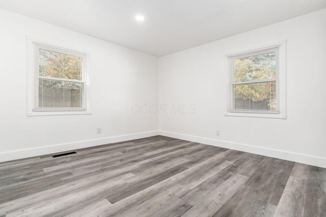 spare room featuring hardwood / wood-style floors