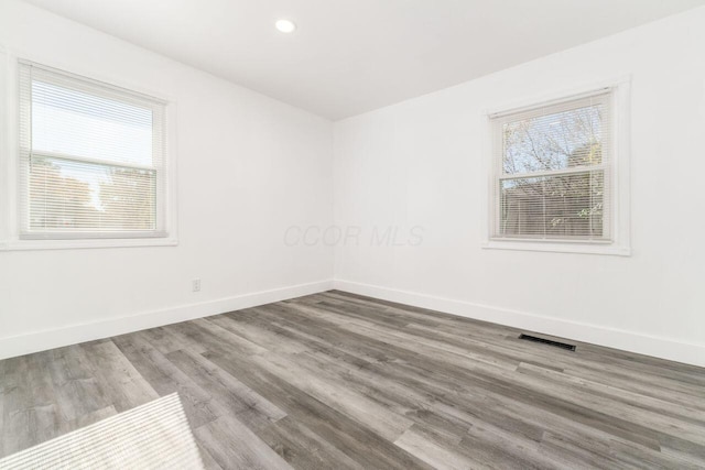 unfurnished room with wood-type flooring