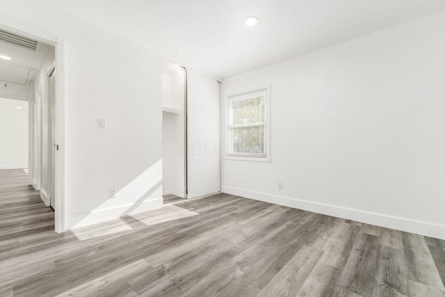 spare room with light wood-type flooring