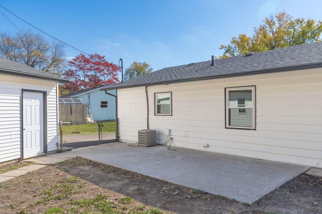 rear view of property featuring a patio and central AC