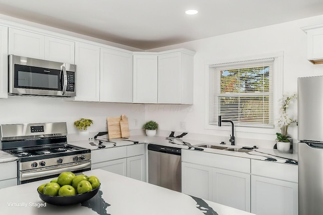 kitchen with white cabinets, sink, and stainless steel appliances