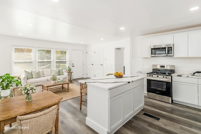 kitchen featuring white cabinets, hardwood / wood-style floors, and stainless steel appliances