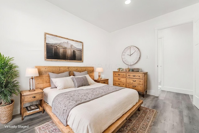 bedroom with dark hardwood / wood-style flooring