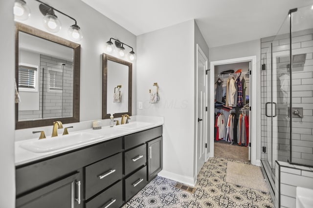 bathroom featuring tile patterned floors, vanity, and walk in shower