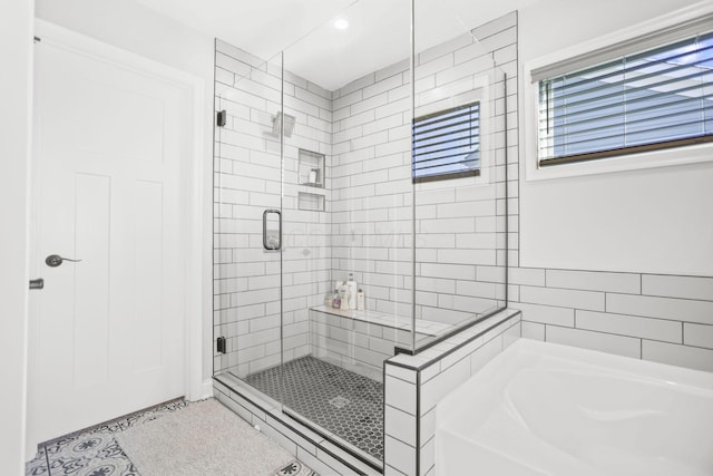 bathroom featuring tile patterned floors and shower with separate bathtub