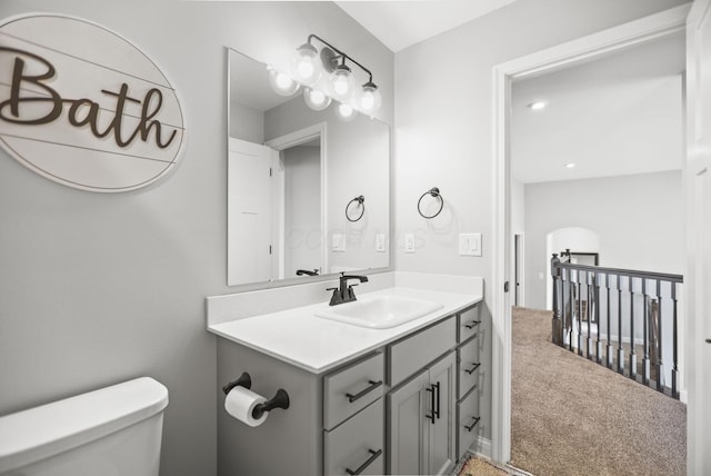 bathroom featuring vanity and toilet