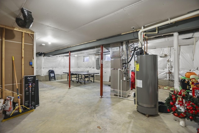 basement featuring heating unit, electric panel, and water heater