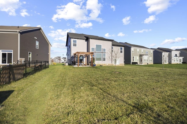 rear view of house with a lawn and a pergola