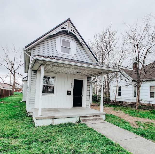 view of front of home with a porch and a front lawn