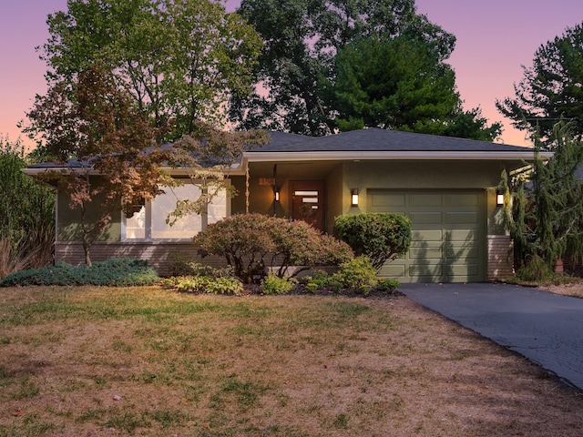 view of front facade with a lawn and a garage