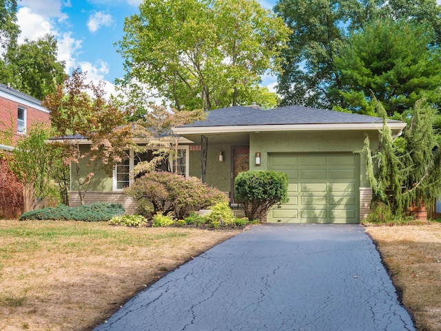 view of front facade with a front lawn and a garage